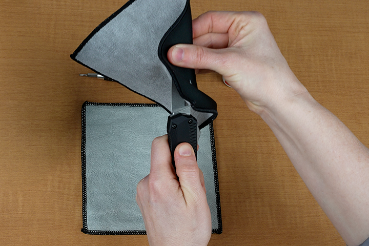 Person wiping Kershaw Livewire blade with cloth